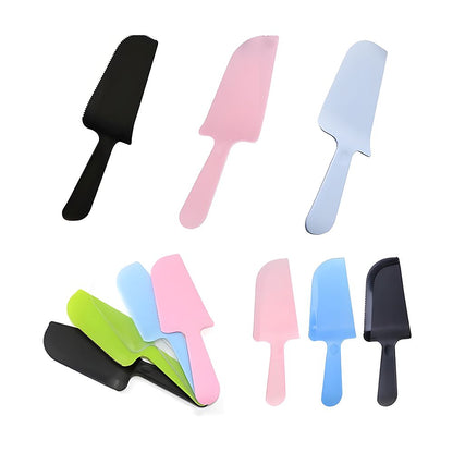 Colorful plastic cake knives in pink, blue, black, and green, displayed individually and stacked. The tone is playful and vibrant.