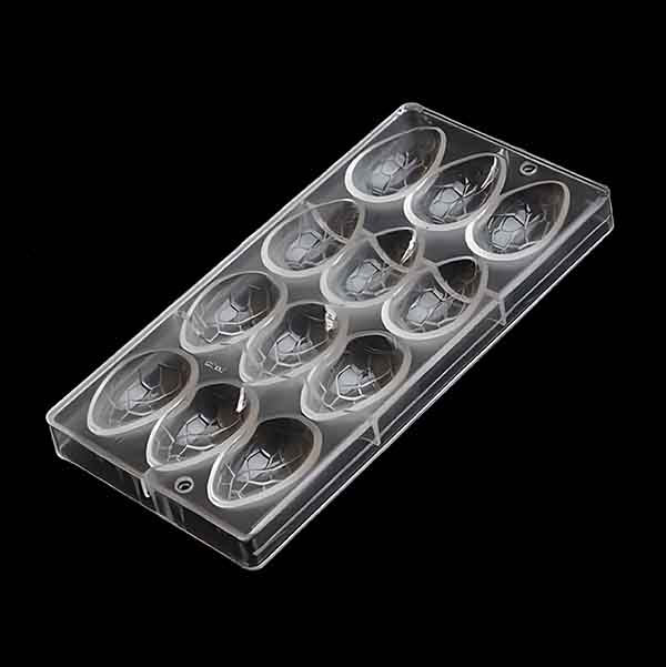 An egg-shaped chocolate mold made of clear plastic, featuring twelve egg cavities. Each cavity is outlined, allowing for the creation of chocolate eggs. The mold is placed on a black background.