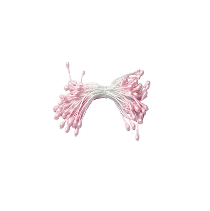 A bundle of decorative pink stamens with glossy tips and white stems, resembling flowers, is arranged neatly against a plain white background.
