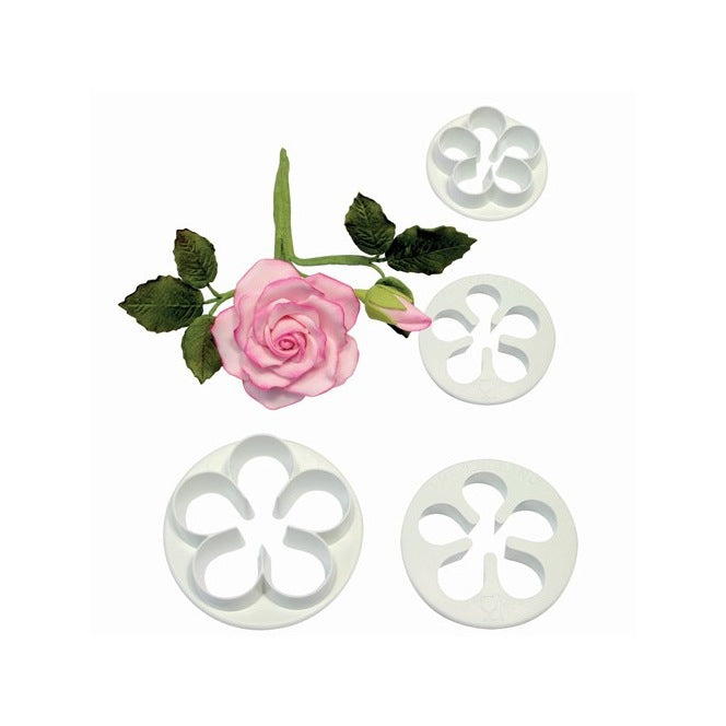 A floral petal cutter set consisting of four white plastic cutters, each shaped with flower petal designs. In the center of the image, there is a pink rose with green leaves and a stem, complementing the cutters. The background is plain to emphasize the product.