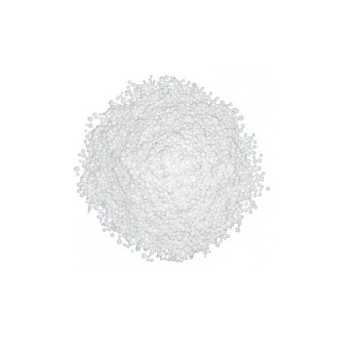 A mound of white crystalline granules on a plain background, representing isomalt, a sugar substitute.