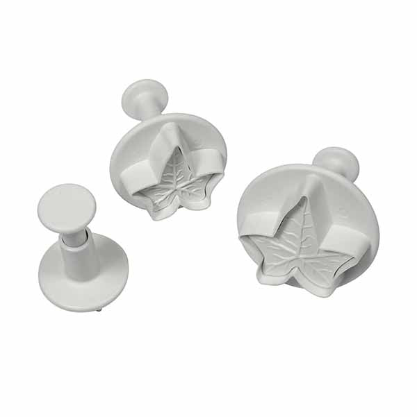 Three plunger cutters in the shape of ivy leaves. The cutters are made of white plastic, with two larger cutters featuring detailed leaf designs and a smaller plain cutter. Each cutter has a plunger handle on top for easy use.