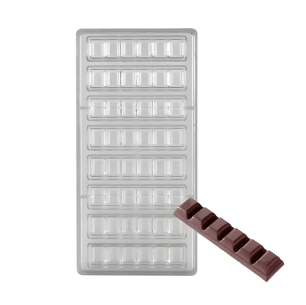 Clear plastic mold with rectangular compartments for making chocolate bars. One brown chocolate bar is placed diagonally over the bottom right corner.