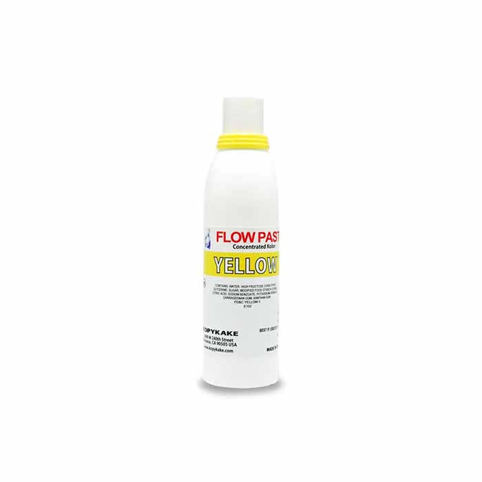 A white bottle of "Kopykake Flow Paste Yellow," featuring a yellow cap and a label that reads "FLOW PASTE" in bold red letters and "YELLOW" in bold black letters. The label includes additional text about the product and the brand name "Kopykake." The bottle is shown standing upright.