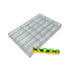 Clear rectangular mold with twelve long, semicircular cavities beside a shiny, green and yellow patterned chocolate bar. Sleek and modern style.