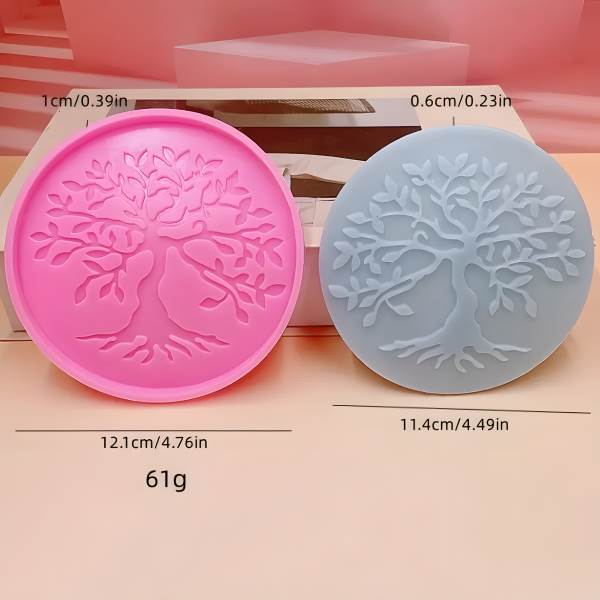 Two round silicone molds, one pink and one blue, displaying detailed tree designs with roots and branches. Dimensions are labeled, showing the pink mold as 12.1 cm (4.76 inches) in diameter and the blue mold as 11.4 cm (4.49 inches) in diameter.