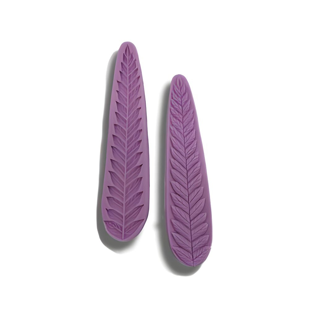 Two purple, leaf-shaped objects with intricate vein patterns placed side by side on a white background, casting subtle shadows to the left.