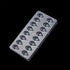 Plastic chocolate mold with 15 teardrop-shaped cavities set against a black background, showcasing a glossy, reflective surface.