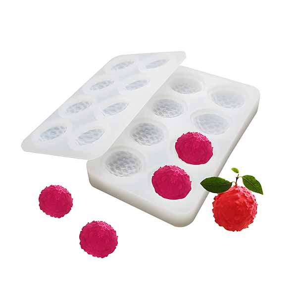 A silicone mold designed for creating realistic lychee-shaped treats, featuring eight cavities. Several vibrant pink lychee replicas are displayed alongside a fresh lychee for comparison, showcasing the mold&