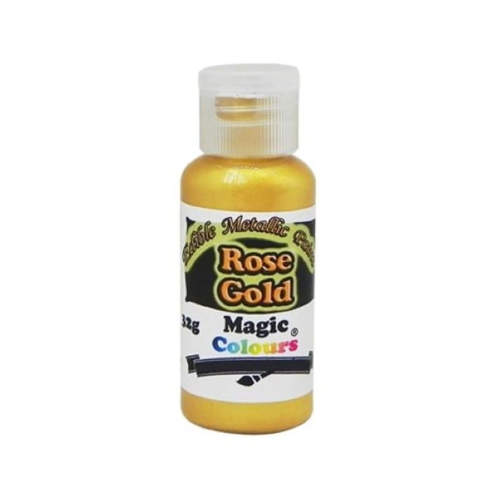 A bottle of edible metallic paint labeled &quot;Rose Gold,&quot; weighing 32 grams. The bottle has a bright gold cap and a white label featuring a black background. The label prominently displays the product name &quot;Rose Gold&quot; in bold, colorful text, along with &quot;Magic Colours&quot; and a note indicating it is an edible metallic paint.