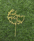A gold acrylic cake topper displayed on a green grass-like surface. The topper features the phrase "God gave me You" in an elegant, scripted font, surrounded by decorative leaf motifs. It is designed for use in cake decorations.
