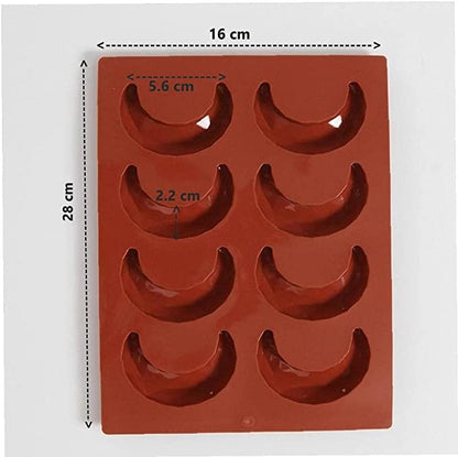 A red silicone mould featuring 8 crescent-shaped cavities arranged in two rows. The mould dimensions are 16 cm in width and 28 cm in height. Each cavity measures approximately 5.6 cm in width and 2.2 cm in depth.