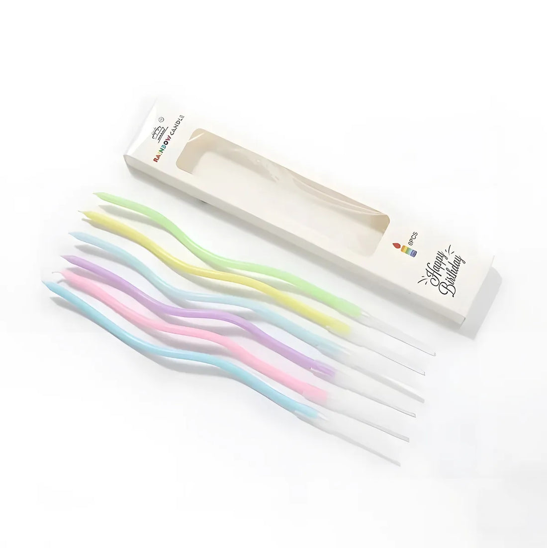 Wavy pastel-colored birthday candles, including blue, pink, yellow, purple, and green, are laid beside an open box labeled "Happy Birthday."