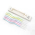 Wavy pastel-colored birthday candles, including blue, pink, yellow, purple, and green, are laid beside an open box labeled "Happy Birthday."