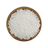 Wooden bowl filled with white pearl sugar grains on a white background