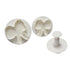A set of three white plunger cutters in the shape of bow ties, including two bow tie-shaped cutters and one plunger tool. The cutters have decorative details like polka dots and a central flower design.