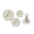 A set of four petal-shaped plunger cutters in white plastic. The set includes three circular cutters of varying sizes, each with a petal shape. To the side, there is a plunger tool designed for use with the cutters.