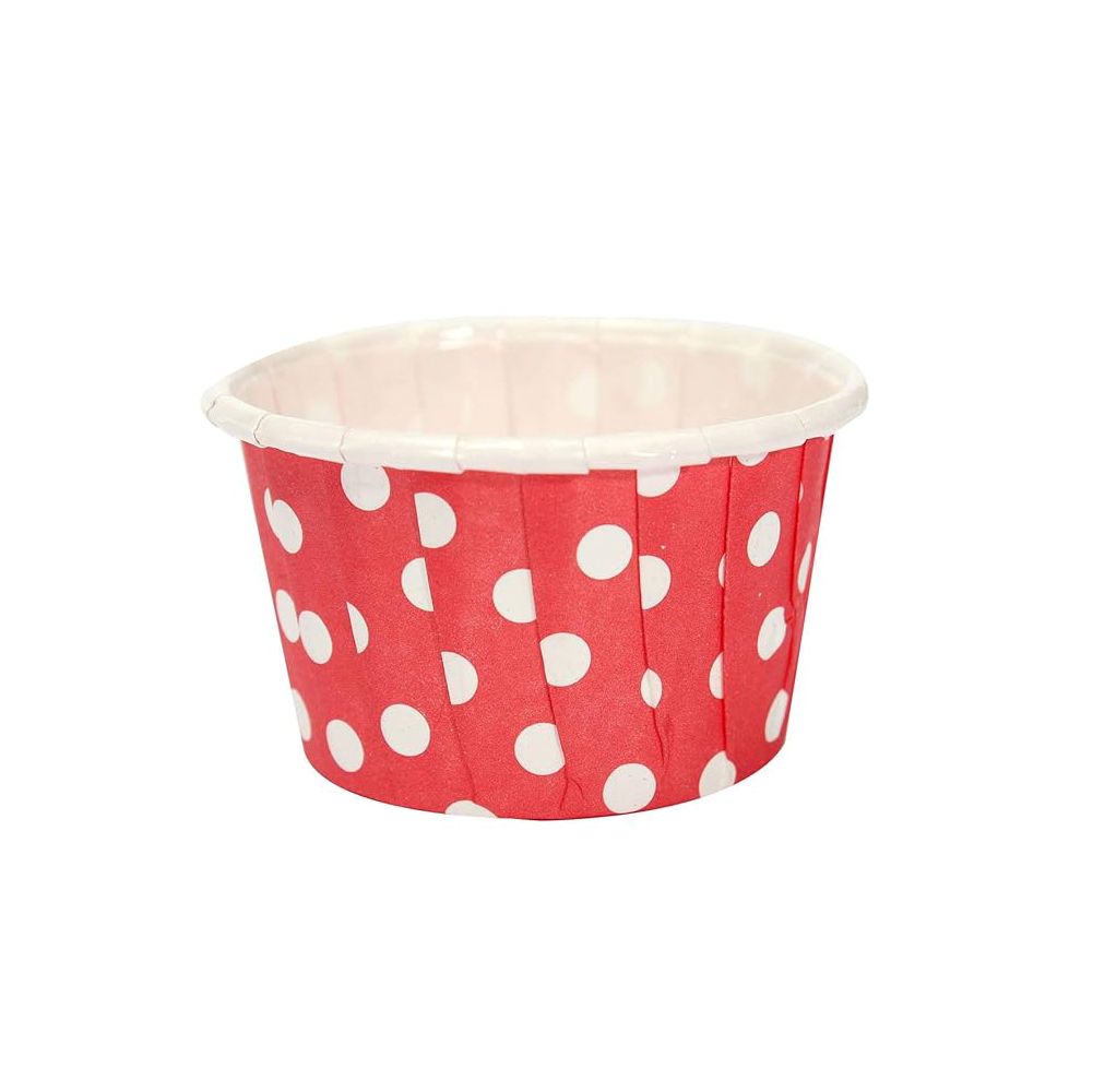 Red cupcake liner with white polka dots on a white background