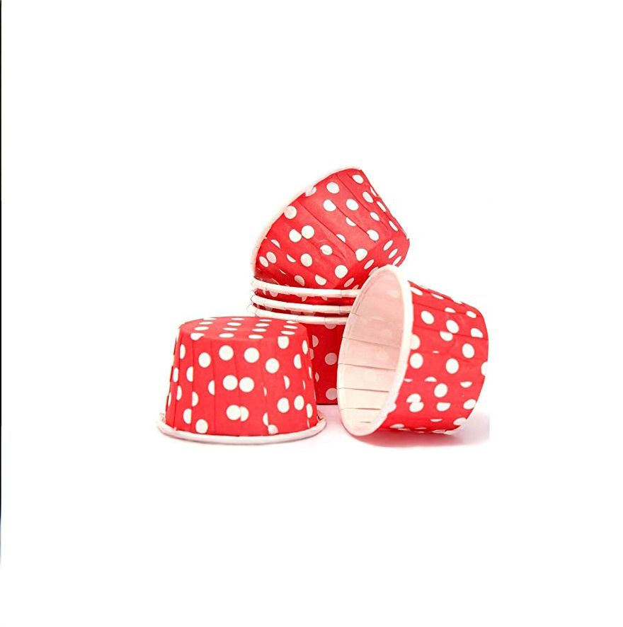 Red paper cups with white polka dots on a white background