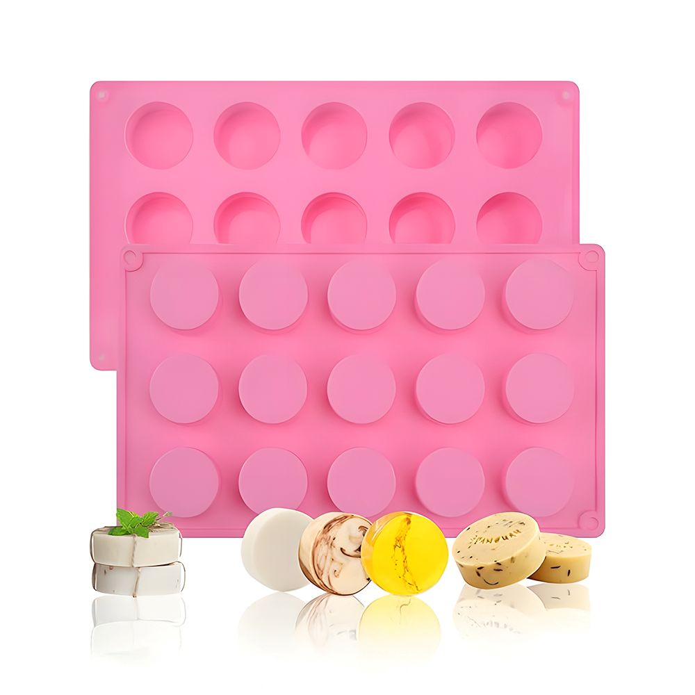 Pink silicone molds with round cavities are shown, with assorted colorful soaps in the foreground, evoking a playful and creative crafting vibe.