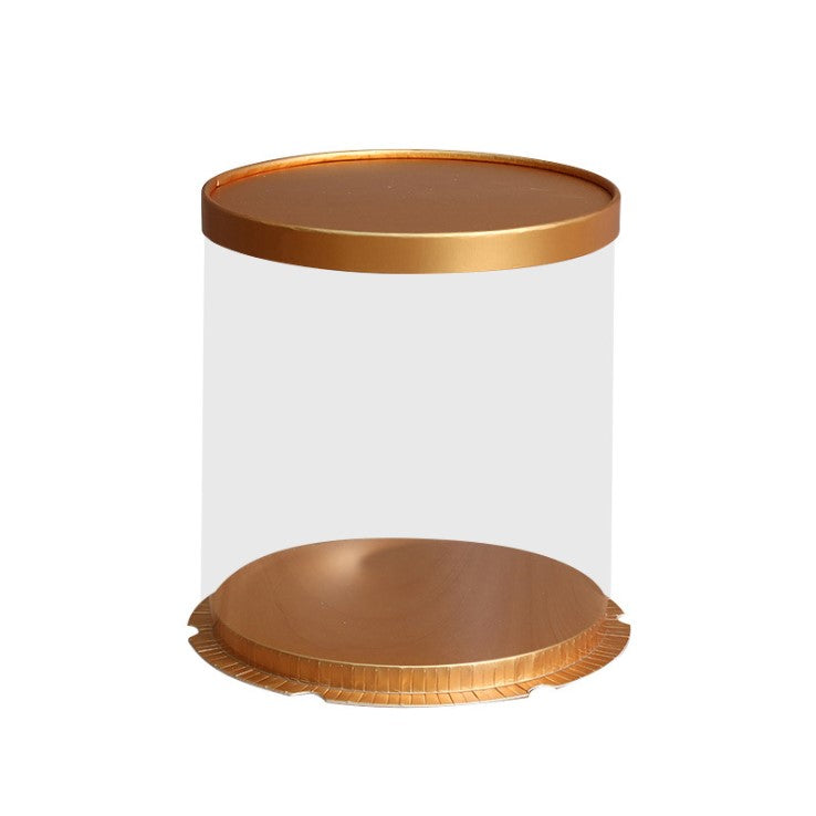 A tall, round cake box made of clear PVC with a shiny gold top and base. The box has a smooth, transparent appearance, allowing visibility of the contents inside. The dimensions are 10 inches in diameter and 10 inches in height.