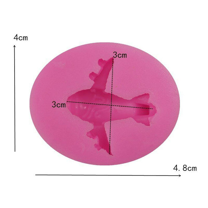 An oval-shaped silicone mold in bright pink, featuring an airplane design in the center. The mold measures approximately 4.8 cm in width and 4 cm in height. The airplane shape is marked with measurement lines indicating it is 3 cm wide and 3 cm tall. The mold is designed for making airplane-shaped items, suitable for baking or crafting.