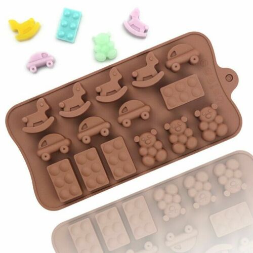 The image shows a silicone mold designed for creating baby toy shapes. The mold is brown and features various toy designs, including rocking horses, cars, teddy bears, and building block shapes. Alongside the mold, there are several small, colorful toy figures: a yellow duck, a green bear, a blue block, a pink car, and a purple block. The overall arrangement emphasizes playful and cute designs suitable for babies or toddlers.