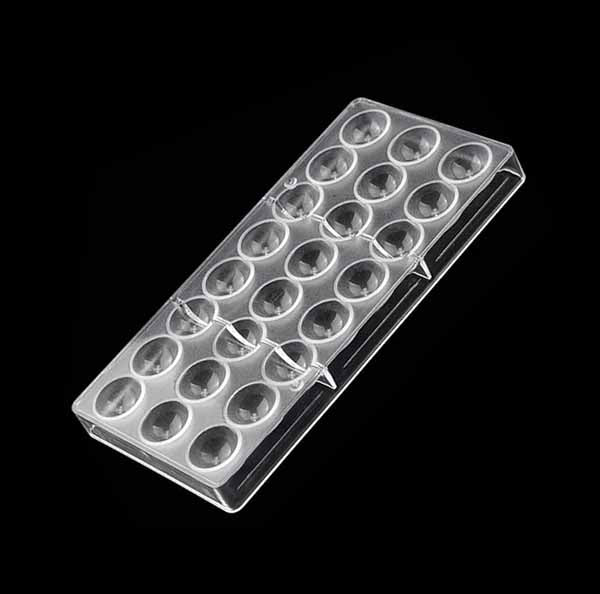 A clear plastic semi-sphere chocolate mold with 15 circular cavities arranged in three rows. The mold is positioned on a black background, highlighting its smooth surface and rounded shapes designed for creating chocolate treats.