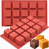 A red silicone mold for making square cubes, featuring a grid of 16 individual cube-shaped cavities. In the foreground, there are two small, colorful cube-shaped chocolates?one yellow and one brown with a decorative ribbon.