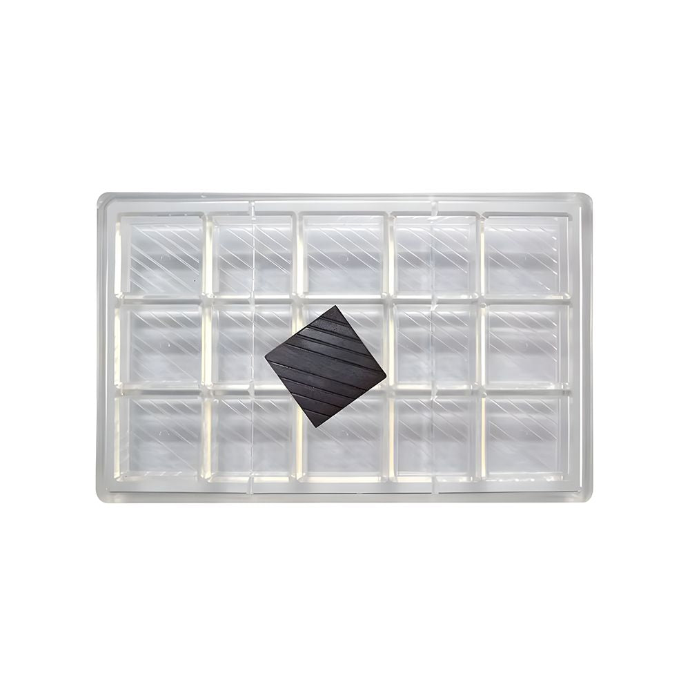 Clear plastic grid tray with 24 square compartments. A black square tile is placed diagonally in the center, creating a contrast with the transparent tray.