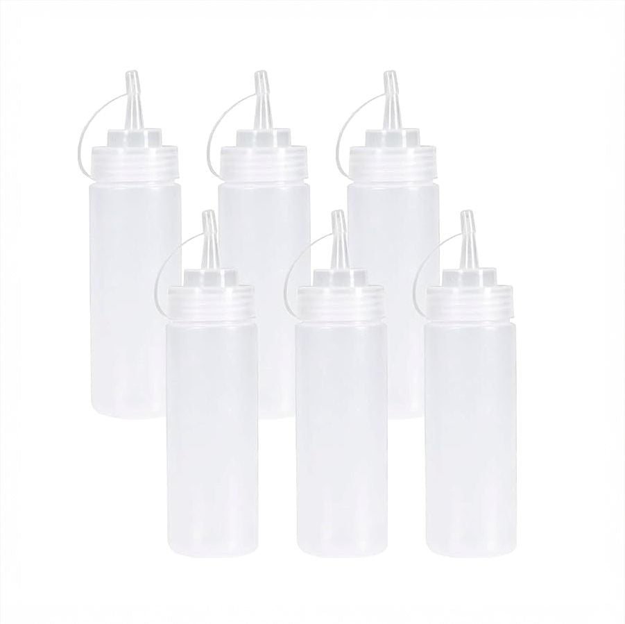 Set of six white squeeze bottles with caps on a white background