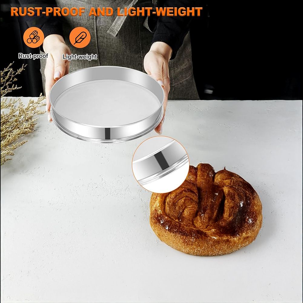 Person holding a shiny, round silver tray above a loaf of bread on a white surface. Text indicates it is rust-proof and lightweight. Cozy kitchen vibe.