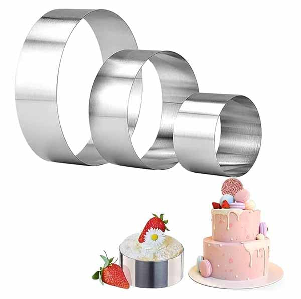 The image features three metal cake rings of varying sizes, arranged from largest to smallest, with a shiny silver finish. Below them, there is a depiction of a round cake topped with colorful decorations, including macarons and a strawberry. Additionally, there&