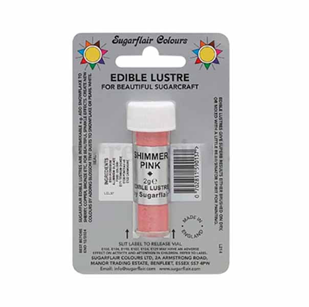 The image shows a product packaging for "Sugarflair Edible Lustre Glitter" in a 2g pink variant, labeled as "Shimmer Pink." The container is cylindrical and clear with a white lid, and is displayed on a grey backing that includes colorful sun designs. The text on the packaging highlights that it is an edible lustre suitable for sugarcraft, with usage instructions and contact information for the manufacturer. The barcode and other product details are also visible on the packaging.