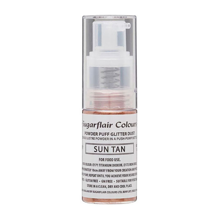 An image of a 10g bottle of Sugarflair edible glitter dust spray labeled &quot;Sun Tan.&quot; The transparent container features a pump dispenser on top, and the label includes the product name, usage instructions, and information regarding food safety. The glitter dust appears to have a warm, tan color.