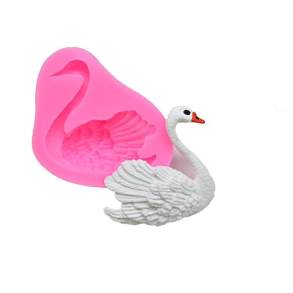 A pink silicone mould shaped like a swan, displaying intricate details of the bird&