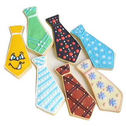 A collection of colorful tie-shaped cookies decorated with various patterns, including polka dots, stripes, flowers, and a smiley face, showcasing creativity and fun designs made with a tie-shaped cookie cutter.