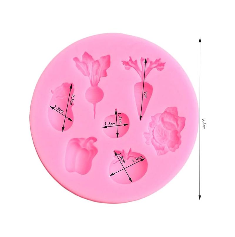 Pink circular silicone mold featuring various vegetable shapes, including a carrot, beet, and pepper, each with measurements. Mold has a playful tone.