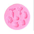 A round pink silicone mold depicts seven recessed vegetable shapes: carrot, radish, eggplant, cauliflower, apple, tomato, and bell pepper.