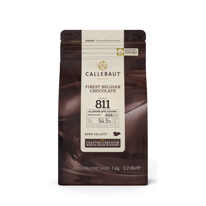 A bag of Callebaut Finest Belgian Chocolate, Recipe No. 811, featuring dark callets with 54.5% cocoa content. The packaging highlights its use for all-round applications with medium fluidity, crafted in Belgium from whole bean roasted cocoa. The bag weighs 1 kg (2.2 lbs).