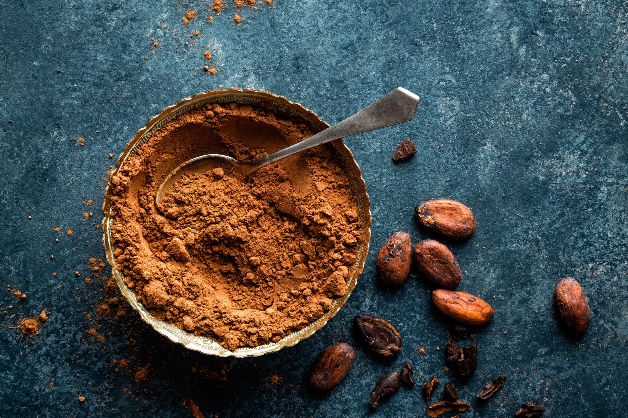 cocoa-powder-and-cacao-beans-on-dark-background–top-view-654544408-5ab44e6304d1cf00361f1b33