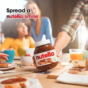 Nutella jar on a breakfast table with family in the background, featuring the text 'Spread a Nutella smile.' Ideal for promoting Nutella products on Cake Craft UAE.